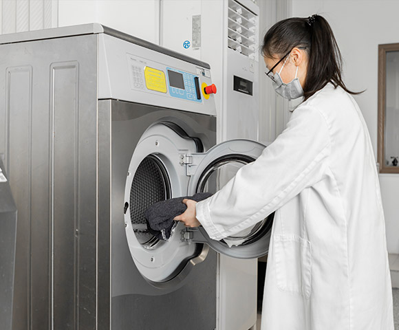 A technician is conducting washing test under the ASTM standards